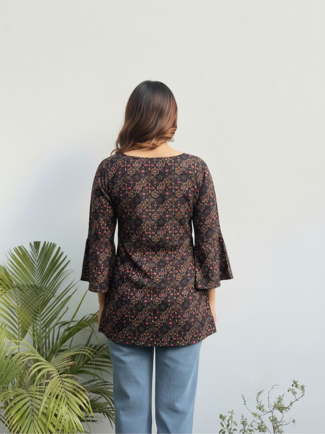 Woman wearing a floral blouse with a plain background