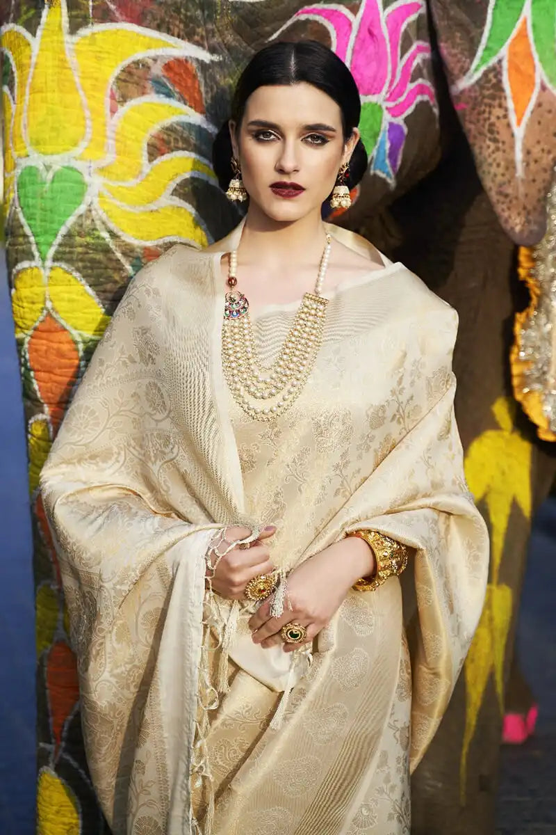 Woman in a traditional outfit with jewelry against a colorful floral background