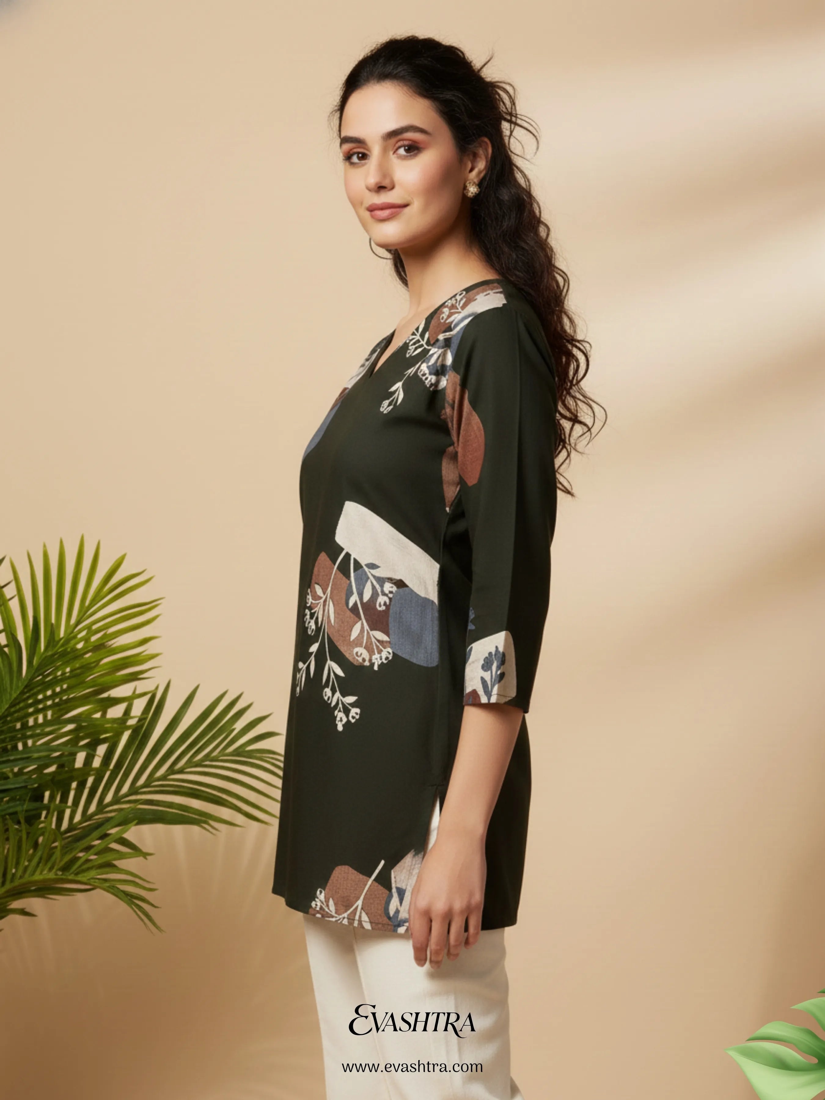Woman wearing a black floral top with a beige background