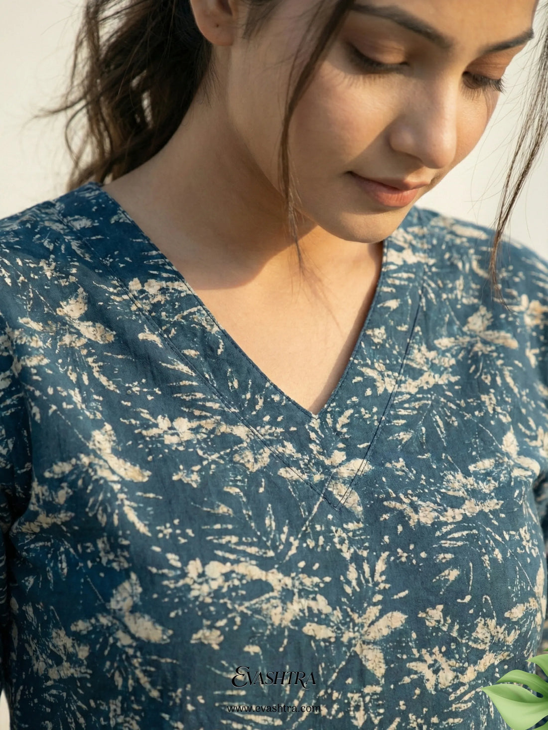 Person wearing a blue floral patterned shirt with 'Casablanca' branding.