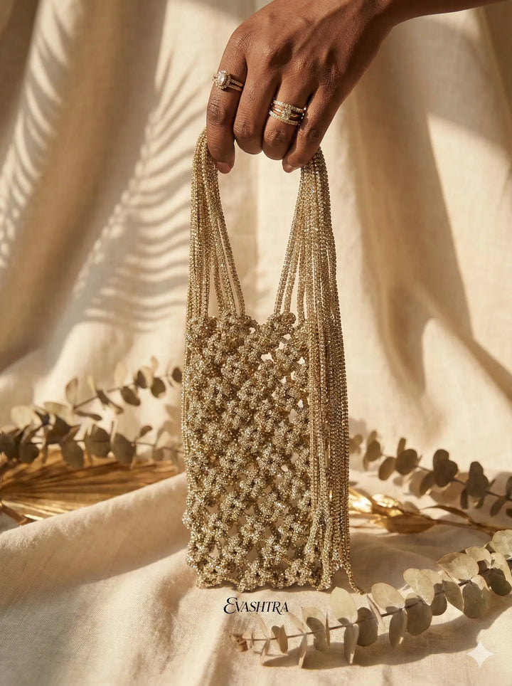 Hand holding a beaded handbag with a neutral background